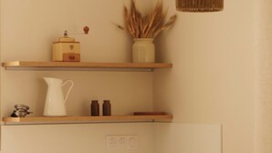 A modern kitchen with wooden shelves, a white countertop, and a hanging light fixture. - New apartment "La vieille maison", near Serre Chevalier (Villar-Saint-Pancrace)