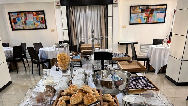 A buffet table with various food items, including meats, cheeses, and pastries, in a hotel setting. - Hotel La Costiera (Giugliano in Campania)