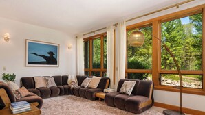 A living room with a sectional sofa, a coffee table, and a floor lamp.