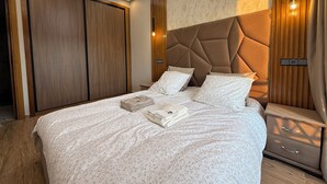 A modern bedroom with a large bed, wooden wardrobe, and a nightstand with drawers. - Sunny & Luxury Retreat Casablanca (Casablanca)