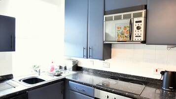 Refrigerador, microondas, cafetera y tetera y utensilios de cocina