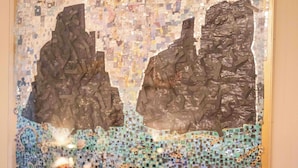 A mosaic artwork on a wall above a sofa. - Palazzo Carafa Santangelo - historic residence of the 400'in the heart of the ancient city (Napoli)