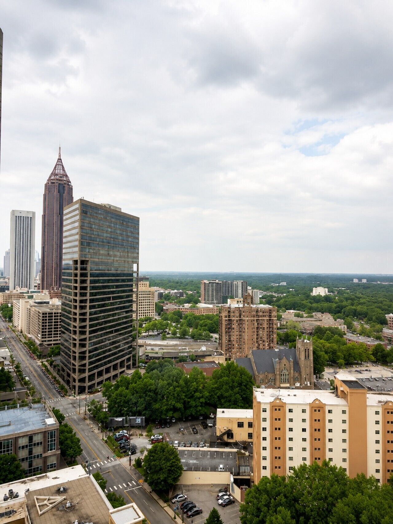 A cityscape with various buildings, including a prominent skyscraper and a church.