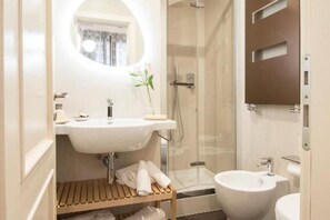 A compact bathroom with a sink, toilet, and shower. - Diva apartment near San Marco square (Venezia)