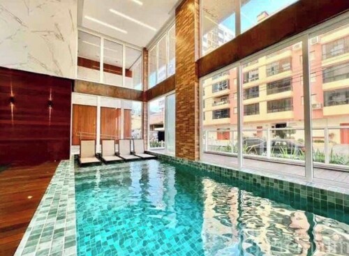 Apartment with safety netting, heated pool, and gym.