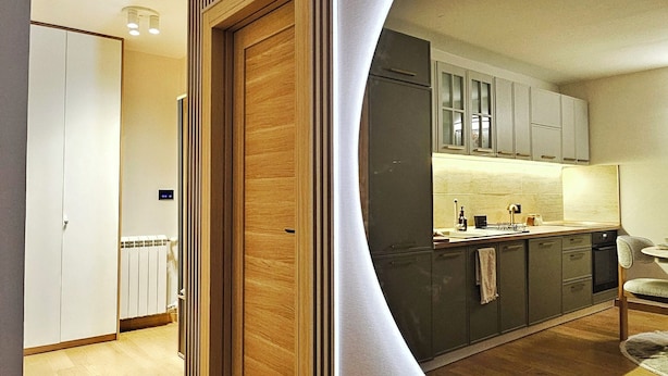 A modern kitchen with wooden cabinets, a built-in oven, and a large island. - Peaceful 1-bedroom apartment in charming Novi Sad (Novi Sad)