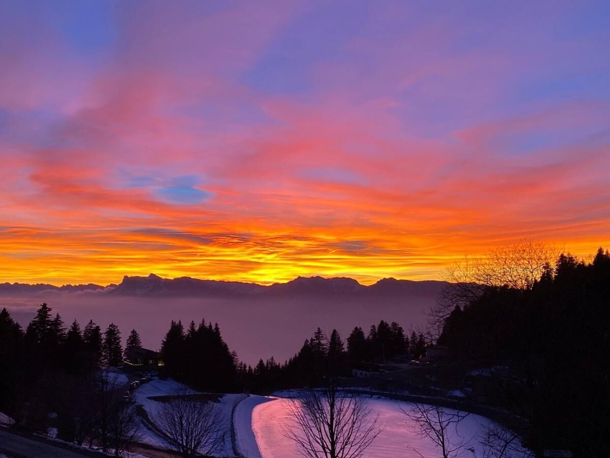 A mountainous landscape with a sunset.