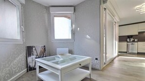 A modern kitchen with white cabinets, a stainless steel refrigerator, and a window with a view of the outdoors. - 3 bedrooms with elevator parking hyper center Trouville (Trouville-sur-Mer)