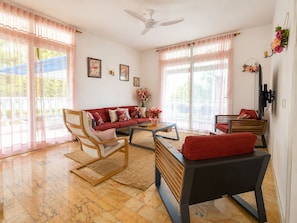 A living room with a sofa, chairs, a coffee table, and a TV. - Tropical Villa - Comfort and Relaxation (Petit-Bourg)