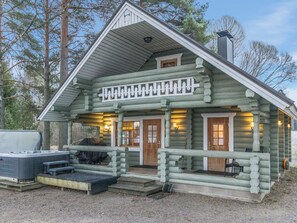 A log cabin with a porch, a hot tub, and a chimney. - Vacation home Muikku by Interhome (Padasjoki)
