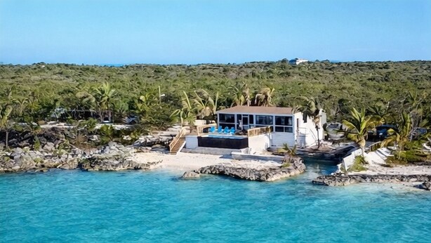 A coastal property with a pool, a covered deck, and a view of the sea. - Pool, Beach, kayaks, great snorkeling, calm side of the island,  (Exuma)