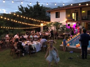 An outdoor dining area with string lights, tables, and chairs. - Beachfront CASA ANDREA, Playa Negra/private pool.Steps away from "private" beach (Los Pargos)