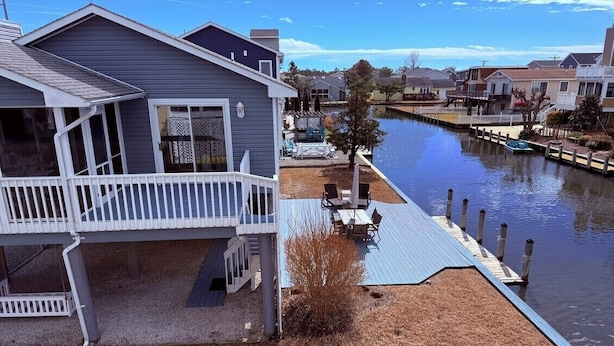 A residential property with a dock extending into a canal, surrounded by other houses. - Waterfront, Dock, Deck, Walk to the Beach, bring your kayaks/boat! (South Bethany)
