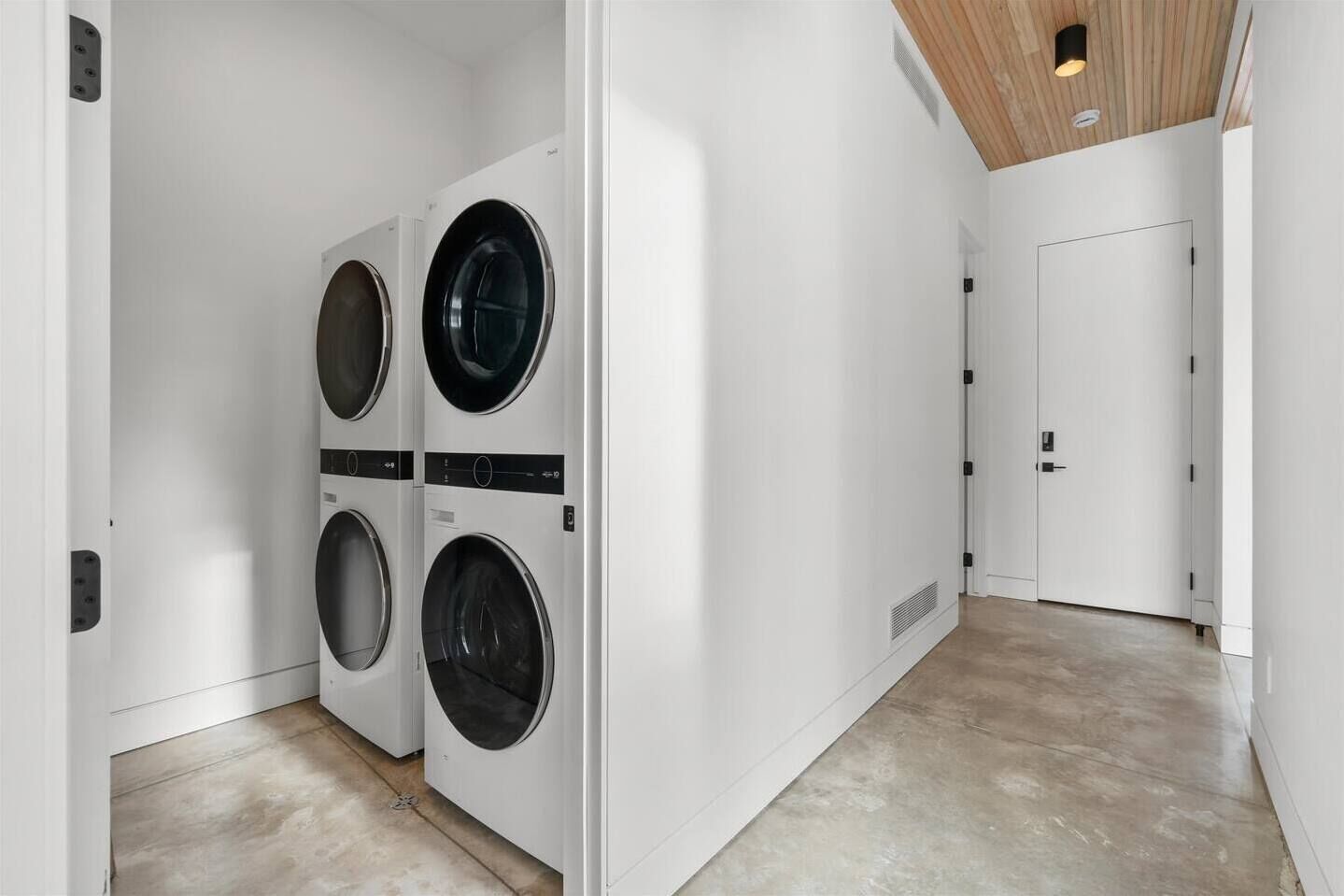 Modern entry hall with in-unit washer/dryer and sleek designer finishes