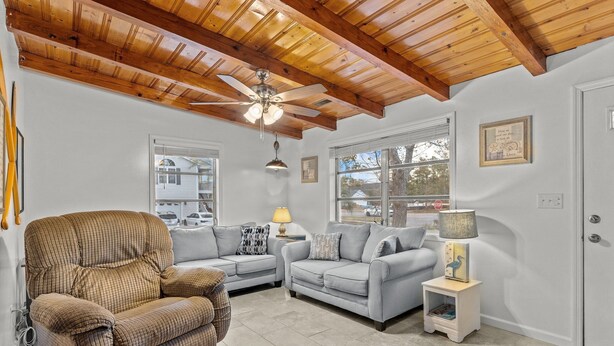 A living room with two sofas, a chair, a ceiling fan, and a lamp. - Pool! Blocks away from beach. Dog-Friendly! (Oak Island)