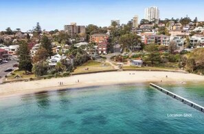 On the beach, beach towels - Stylish 1-bedroom waterfront apartment in Manly with free parking, gym and sauna (Manly)