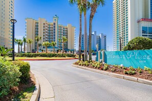 A hotel entrance with a sign reading "Romar Place" and a road leading to it. - NEW:) 3BR Luxury Oceanfront Bliss! (Orange Beach)