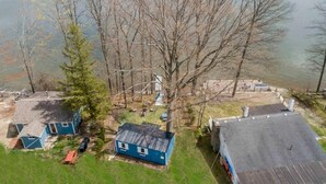 A lakeside property with multiple cabins, a dock, and a boat. - Gorgeous 2-bedroom cottage in charming Hammondsport awaits you (Hammondsport)
