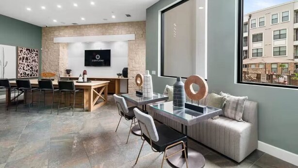 A modern hotel room with a dining area, a sofa, and a large window with a city view. - Great for Children with bunk Beds (Frisco)
