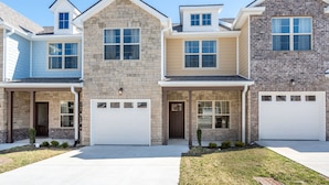 A row of three townhouses with attached garages, each with a distinct exterior style. - 1 King 2 Queens Garage Yard Washer Dryer (Old Hickory)