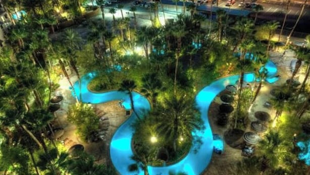 An aerial view of a resort with a winding pool surrounded by palm trees and outdoor seating areas. - Relaxing 1-bedroom resort with AC in marvelous Las Vegas (Las Vegas)