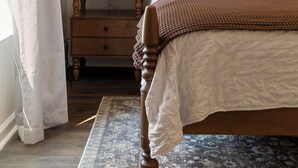 A bedroom with a wooden bed, a nightstand, a lamp, and a window with curtains. - Hot Tub- Sleeps 10- Bourbon Trail- Historic Home (Coxs Creek)