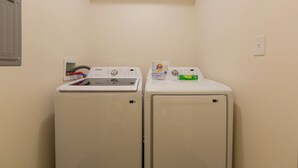 A laundry room with two front-loading washing machines and a dryer. - Hot Tub- Sleeps 10- Bourbon Trail- Historic Home (Coxs Creek)