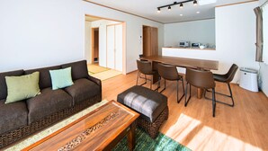 Una sala de estar moderna con sofá, mesa de centro y comedor.