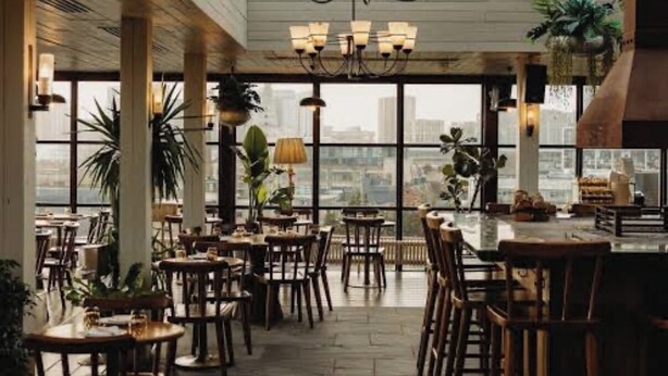 An indoor dining area with multiple tables and chairs, a chandelier, and large windows offering a city view. - Best location! Shoreditch 5 min walk Old St Tube (London)
