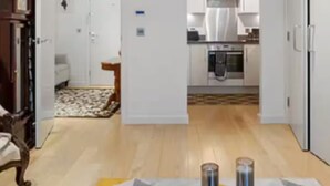 A modern living room with a glass coffee table, a blue bowl with decorative items, and a wooden cabinet. - Best location! Shoreditch 5 min walk Old St Tube (London)