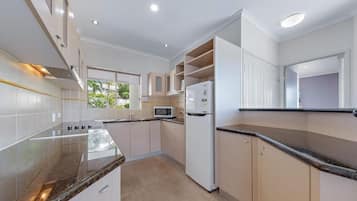 Full-sized fridge, microwave, toaster, cleaning supplies