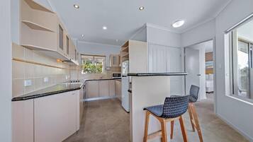 Full-size fridge, microwave, toaster, cleaning supplies