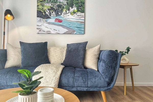 Comfortable lounge with cozy sofa and Queenstown artwork