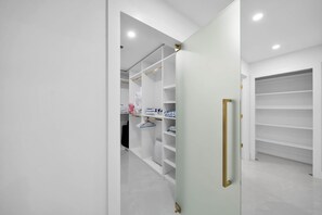 Een moderne kast met witte planken en een schuifdeur.