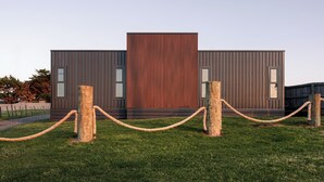 A modern building with a large central panel and smaller side sections, surrounded by a rope barrier. - Style, space & comfort in the heart of Currie (Currie)