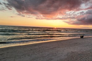 A beach with waves and a sunset. - Southern PAG Beach House Bungalows (St. Pete Beach)