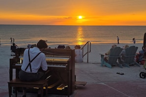 A beachside piano performance with a sunset view. - Southern PAG Beach House Bungalows (St. Pete Beach)