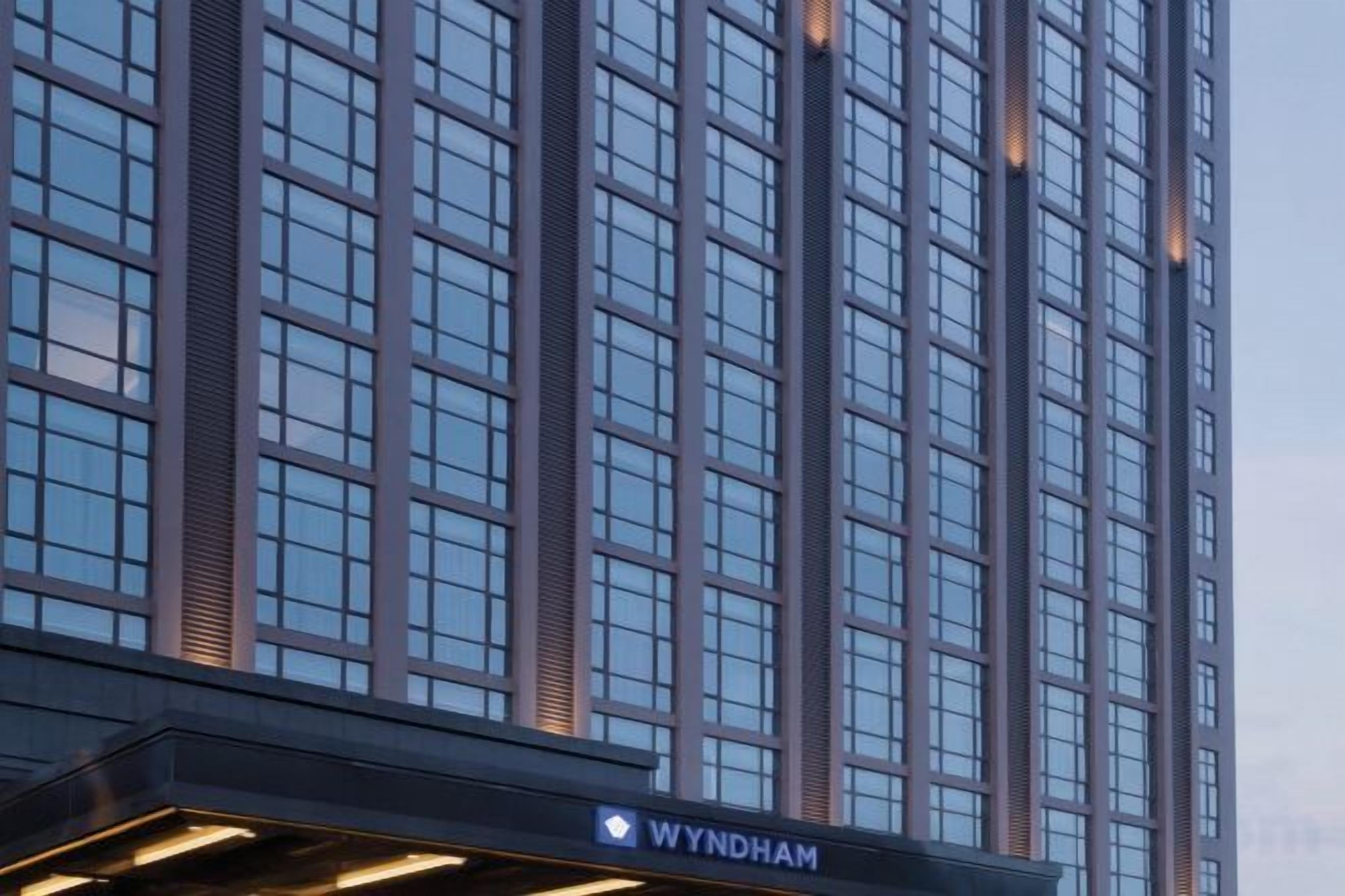 A high-rise building with a prominent 'WYNDHAM' sign at the base.
