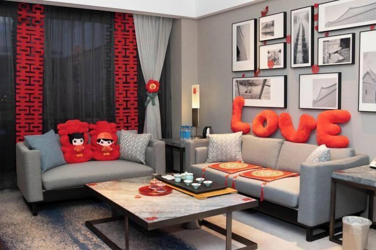 A modern living room with a sofa, coffee table, and wall art.