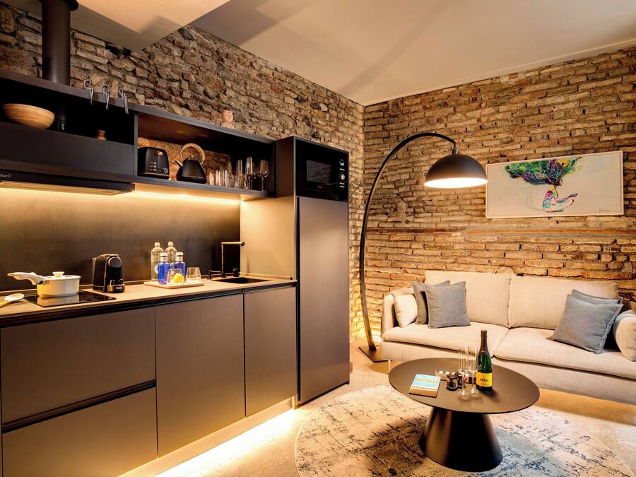 Una cocina moderna con pared de piedra, un sofá y una mesa de centro.