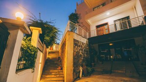 A staircase leading to a building with a balcony, a shop named 'the studio,' and a street lamp. - THE TERRACE TOWNOUSE, a Creative Escape in the Heart of Kigali (Kigali)