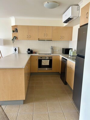 Microwave, oven, stovetop, dishwasher - Marina 403- Modern 1 bedroom apartment in the heart of Forster. (Forster)