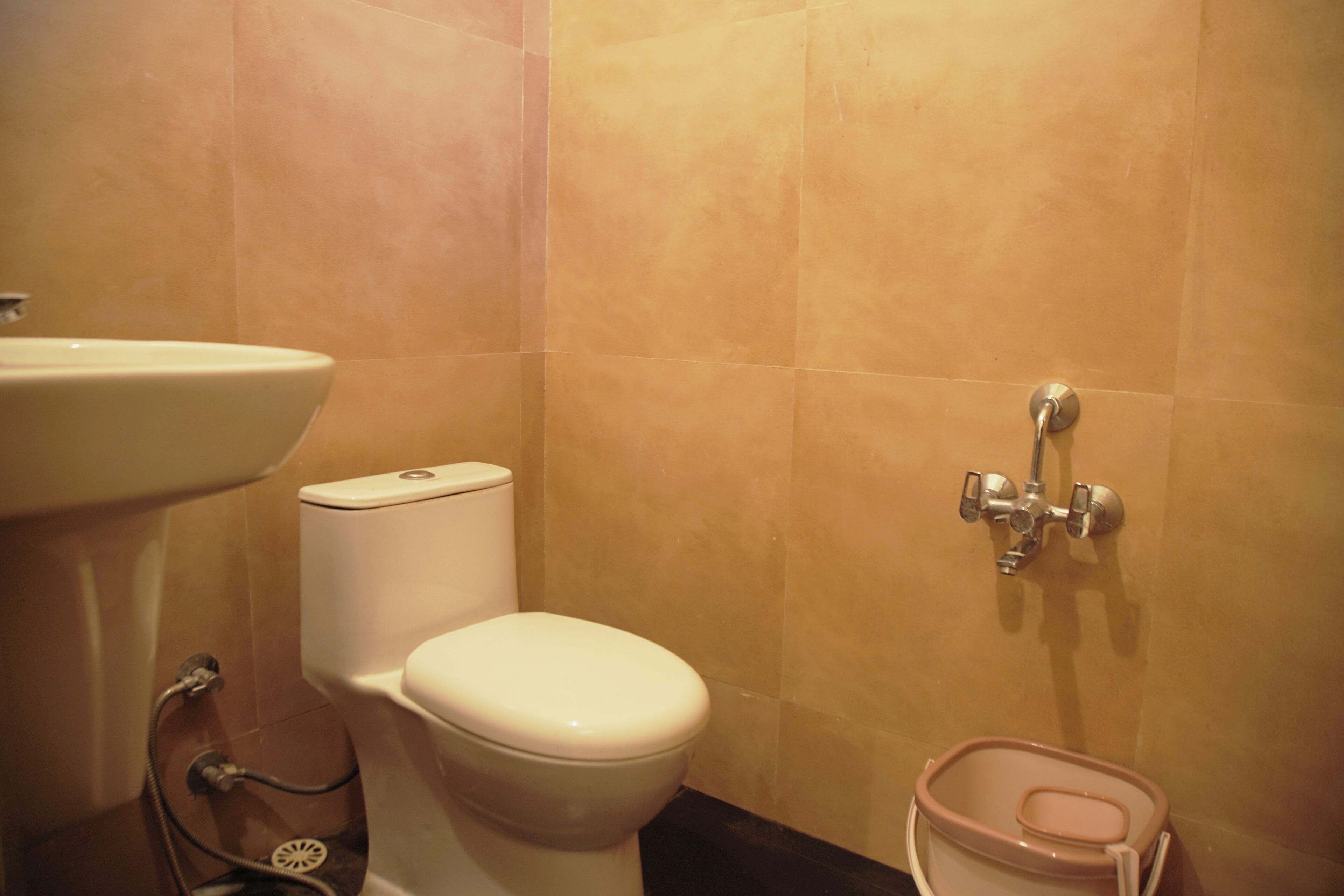 A bathroom with a toilet, sink, and shower.