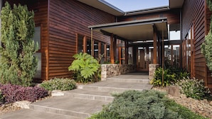 A modern house with a stone pathway leading to a wooden door. - The Haven Montville, is a place of peace, a refuge crowned, 
wrinkles fade & ... (Montville)