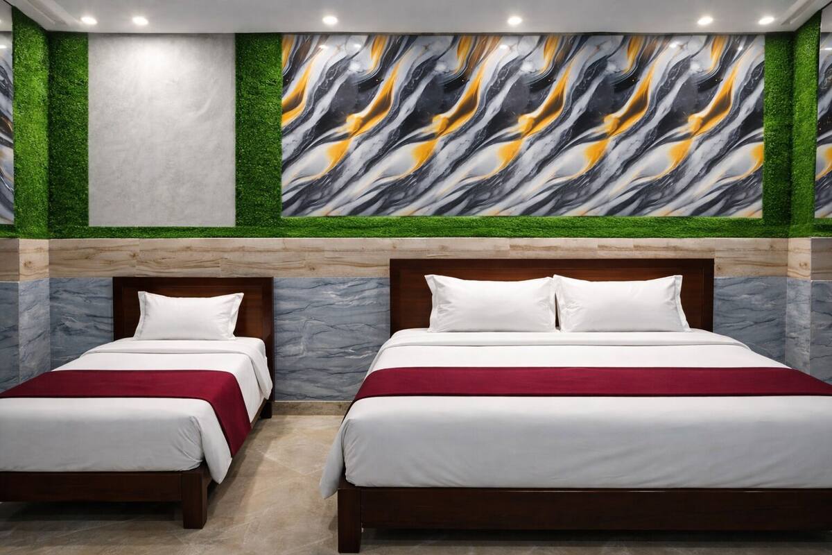 A hotel room with two beds, a marble wall, and a green wall with a marble design.