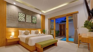 A modern bedroom with a large bed, bedside tables, a bench, and a view of a pool area. - Villa Umahera - Canggu (Canggu)