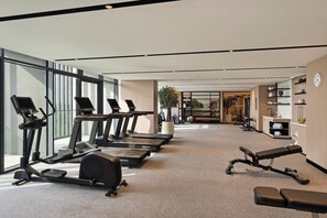 A modern gym with treadmills, a rowing machine, and a bench. - Vida Aljada (Sharjah)