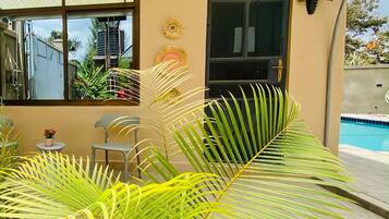 A building with a door labeled 'Rua da', a window, and a pool area with plants.