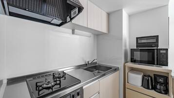 Apartment | Private kitchen | Fridge, microwave, stovetop, cookware/dishes/utensils