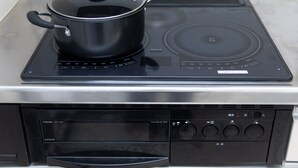 A Toshiba electric stove with a pot on it, control panel, and a built-in oven. - Awaji Central in Kuruma (Awaji)